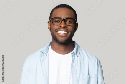 Portrait of smiling black man in glasses isolated in studio