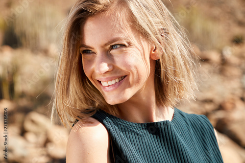 Beautiful young model smiling in desert