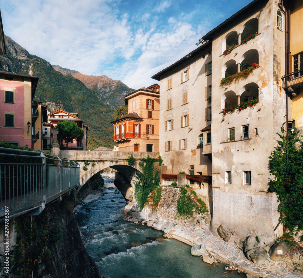 Scenic view on small river flowing through gorge between houses in cute town of Chiavenna, Italy.