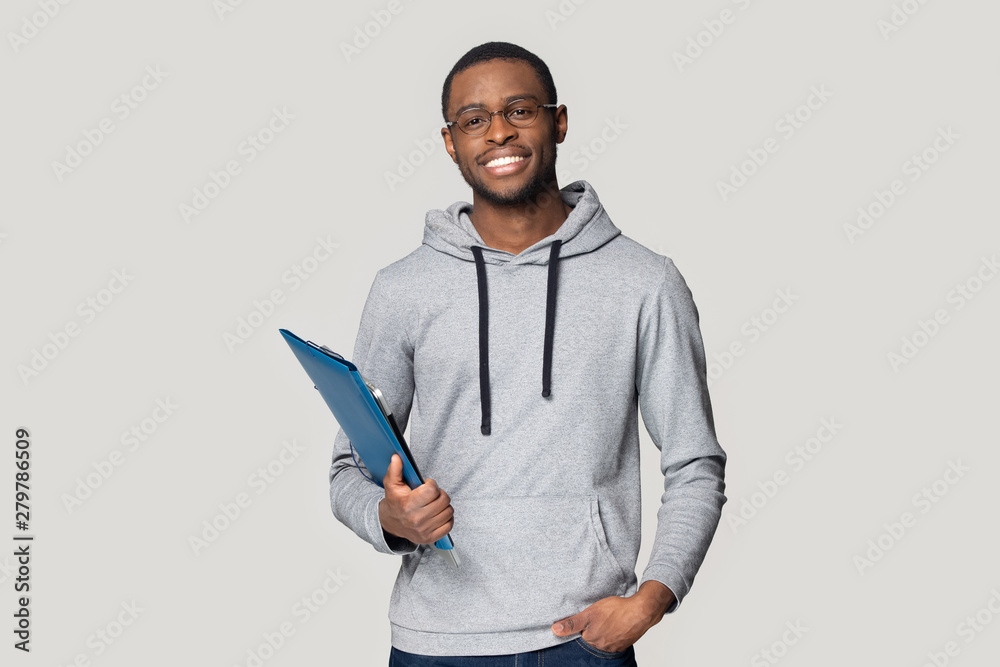 Smiling black male student stand holding binder case - obrazy, fototapety, plakaty 