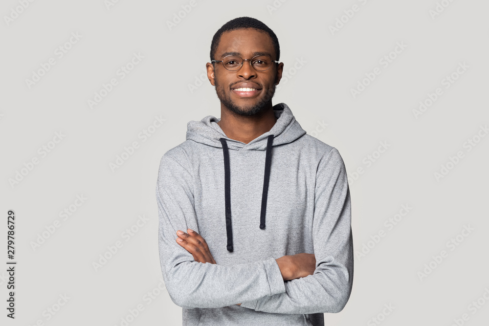 Smiling black male in glasses stand with arms crossed Smiling black male in glasses stand with arms crossed