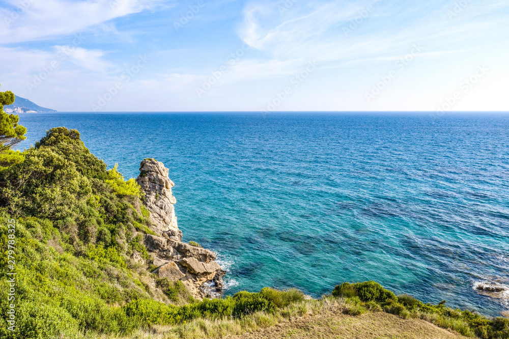 Aerial view of beautiful seashore in summer. Rocky beach and green islands seen from above.