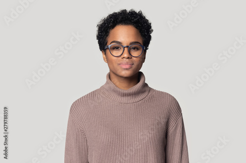 Headshot of black woman in glasses posing isolated in studio