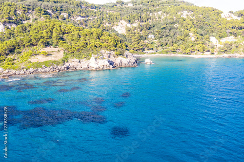 Aerial view of beautiful seashore in summer. Rocky beach and green islands seen from above. © magdal3na