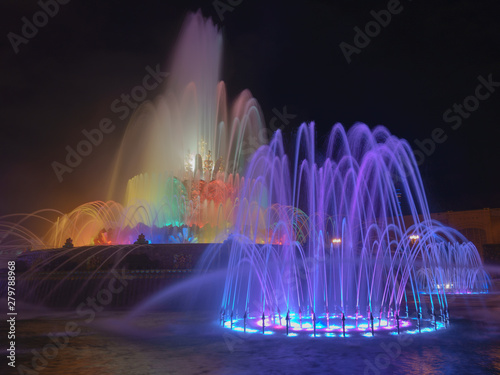 Long exposure image of the sprays of bright colorful fountain Kamenny / Stone flower in night time. Exhibition of Achievements of National Economy / VDNKH park.