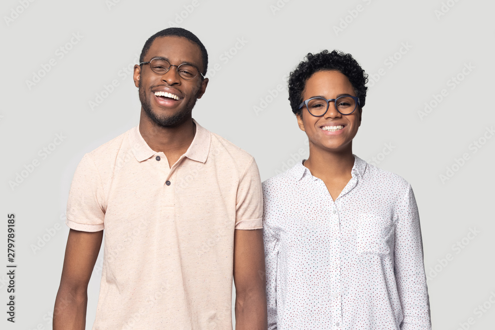 Smiling ethnic couple laugh posing for picture in studio Smiling ethnic couple laugh posing for picture in studio