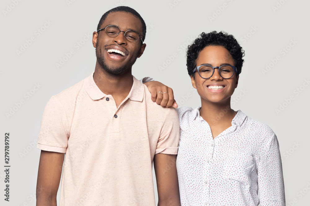 Smiling ethnic couple in glasses laugh posing for picture Smiling ethnic couple in glasses laugh posing for picture
