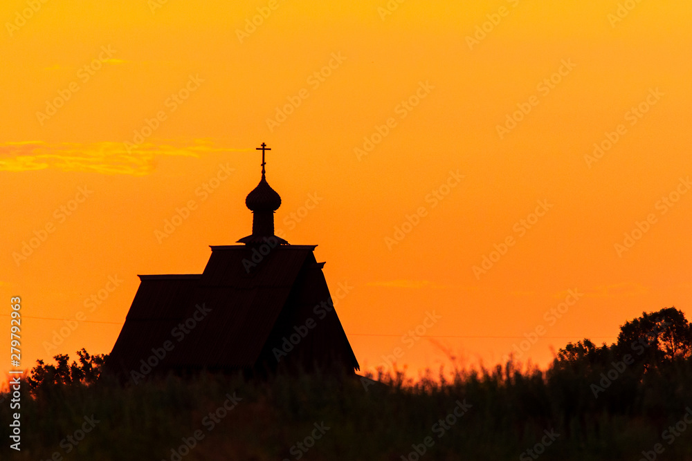 Sunset church cross silhouette in sunset sky clouds. Sunset church silhouette.