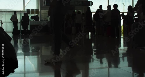 Passenger Queue at Gate before the Flight. People Silhouettes. Reflections on the Floor. Airport Boarding Hall. Time lapse. Tilt Up photo