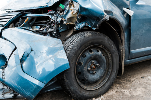 selective focus of damaged blue auto after car accident