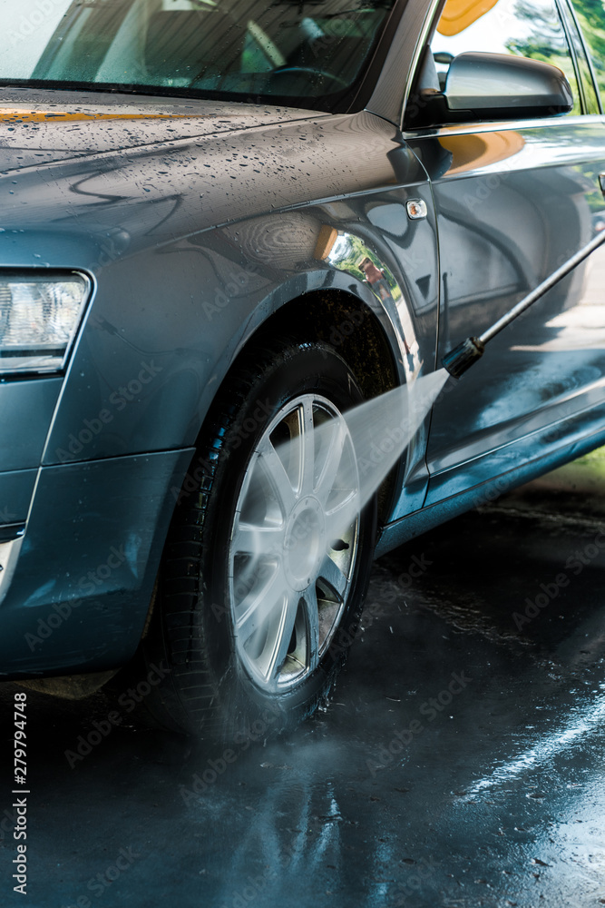 selective focus of water pressure on car wheel selective focus of water pressure on car wheel
