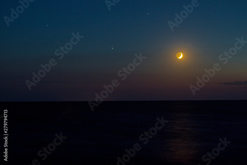The sunset and the moon and the sea