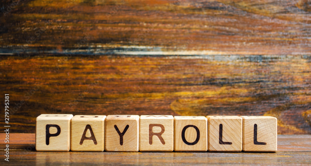 Wooden blocks with the word Payroll. Payroll is the sum total of all compensation a business must pay to its employees for a set period of time or on a given date. Business and Finance. Taxes.