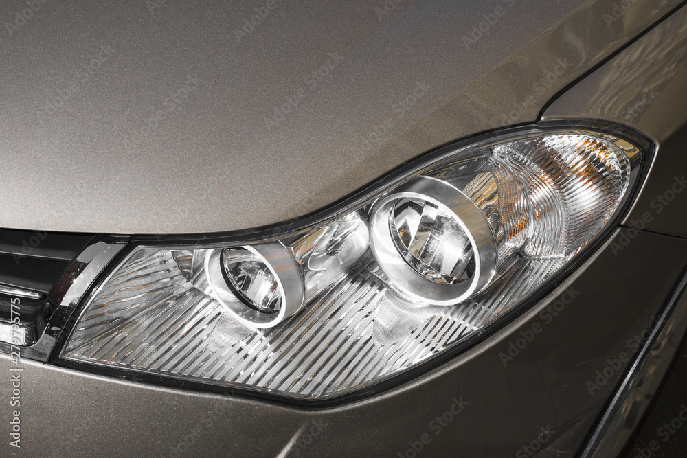 Stylish headlight of dark grey automobile