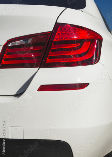 Back of matte white automobile with rear light