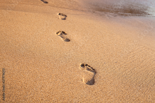 Fototapeta Naklejka Na Ścianę i Meble -  beach, wave and footprints on tropical beach at sunset time