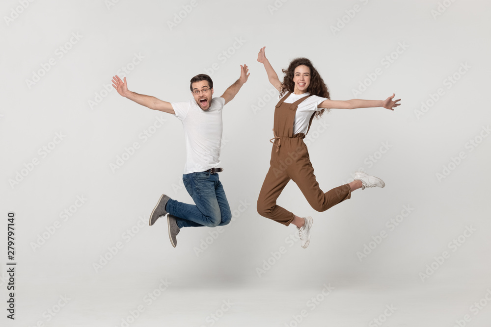 Couple was photographed in a jump isolated on grey background Couple was photographed in a jump isolated on grey background