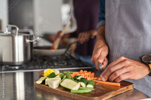 Fotografie Man hand chopping vegetables