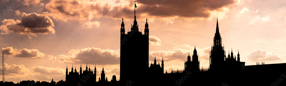 Silhouette of hoses of parliament in London at sunrise with dramatic sky panoramic