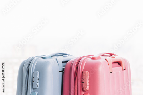 Two blue and pink baggage suitcases