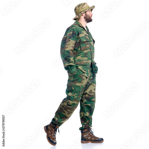 Man in camouflage clothes hiking walking goes on white background isolation