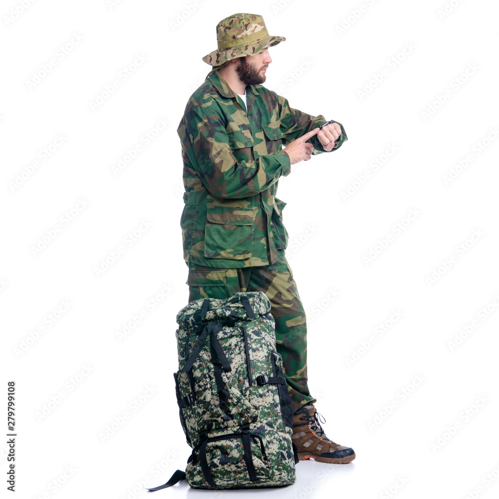 Man in camouflage clothes with backpack hiking standing looking on white background isolation Man in camouflage clothes with backpack hiking standing looking on white background isolation