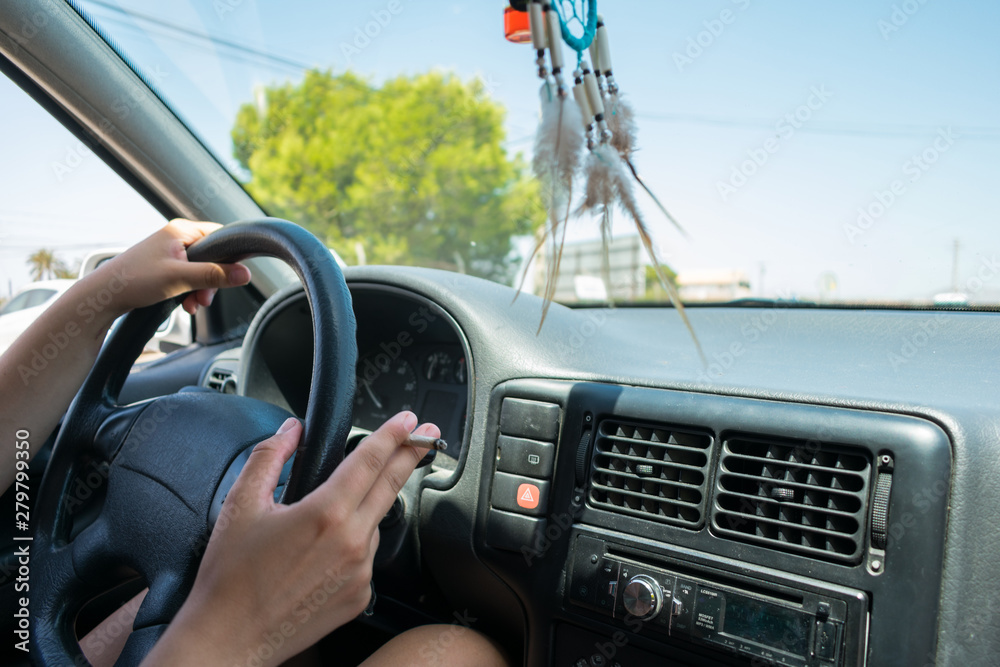 Young woman driver with sunglasses