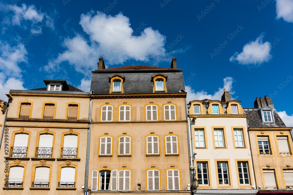 yellow apartments with white shutters on square Place Saint Louis. Metz, France