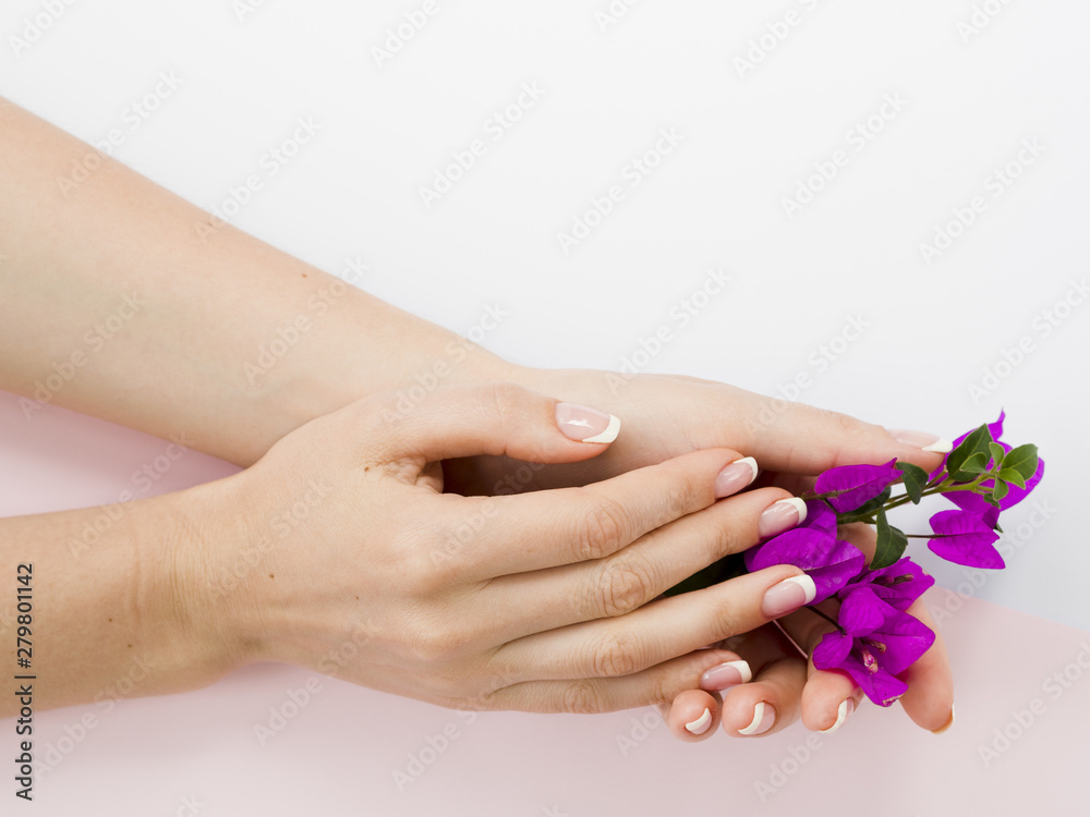 Fototapeta premium Manicured woman hands holding colorful flowers