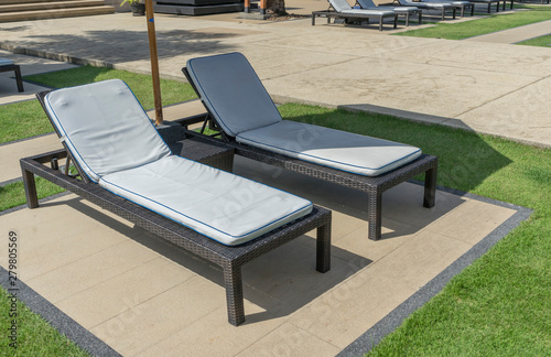 Canvastavla Daybed sun lounger chair by poolside with towel and umbrella