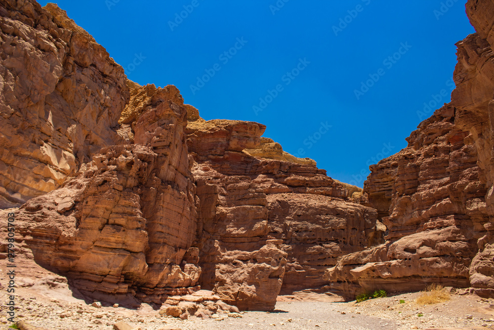 Israeli national heritage extreme touristic destination place Red canyon scenic landscape with lonely trail path way between sharp bare sand stone rocks