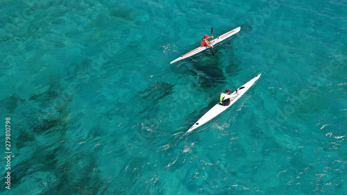 Aerial drone photo of fit men practising sport canoe in tropical open ocean bay with turquoise clear sea © aerial-drone