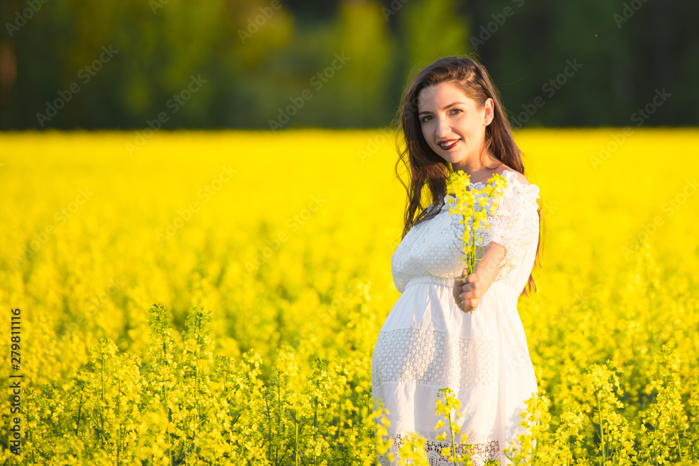 Summer pregnancy, in the warm season. Beautiful portrait of a pregnant woman on a warm summer day in the nature. Pregnancy and season concept Summer pregnancy, in the warm season. Beautiful portrait of a pregnant woman on a warm summer day in the nature. Pregnancy and season concept
