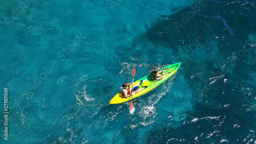 Aerial drone photo of fit couple practising on a colourful canoe in turquoise open ocean bay with crystal clear sea © aerial-drone