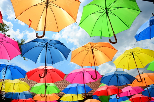 colorful umbrellas on the background of blue sky © predrag