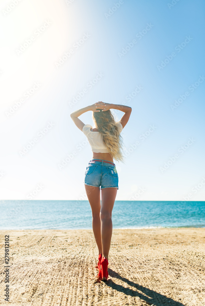 Beautiful bohemian styled and tanned girl at the beach in sunlight Beautiful bohemian styled and tanned girl at the beach in sunlight