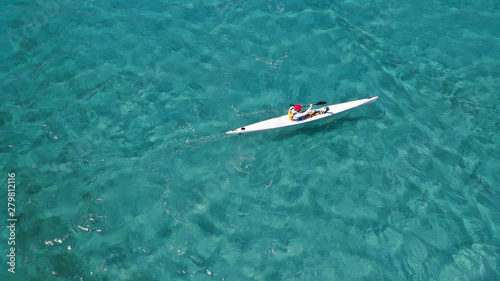 Aerial photo of fit athletes competing on sport canoe in tropical exotic bay with crystal clear turquoise sea © aerial-drone