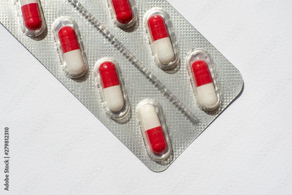 packings of pills and capsules of medicines on white background packings of pills and capsules of medicines on white background