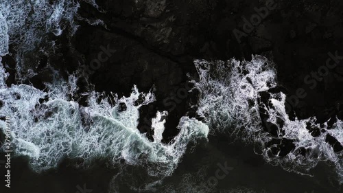 Top down view of giant ocean waves crashing and foaming