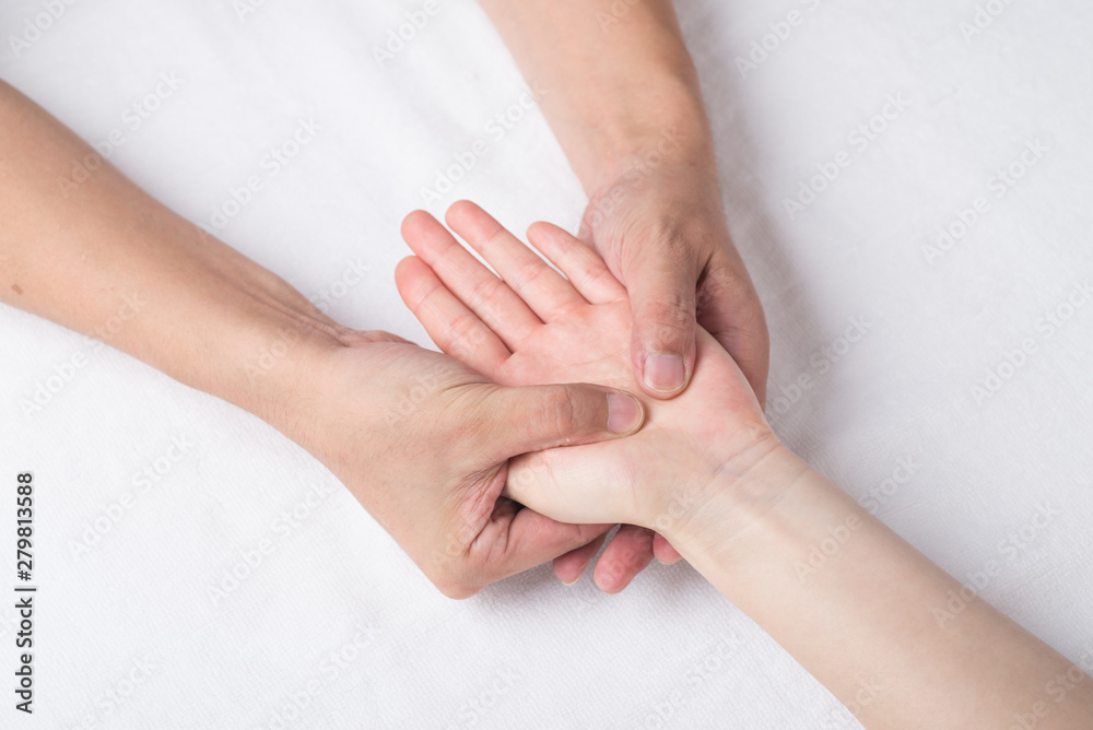 Physiotherapist doing hand massage in medical office Physiotherapist doing hand massage in medical office