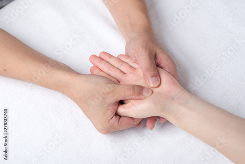 Physiotherapist doing hand massage in medical office