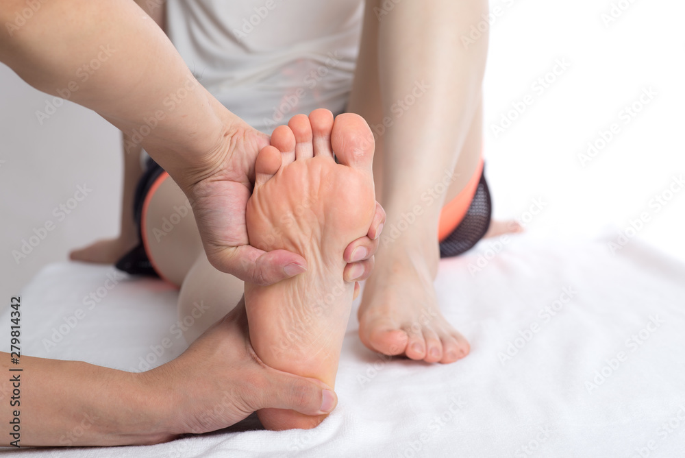 Close-up of female hands doing foot massage Close-up of female hands doing foot massage
