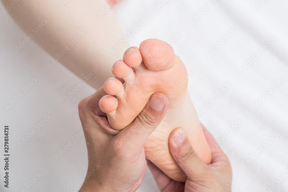 Close-up of female hands doing foot massage Close-up of female hands doing foot massage