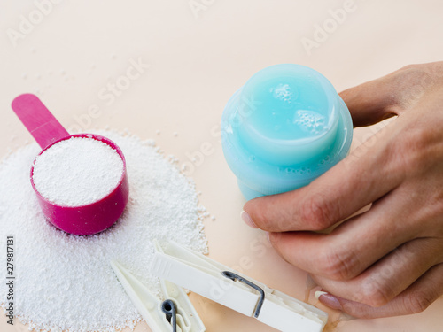 Close-up woman measuring detergent and softner photo