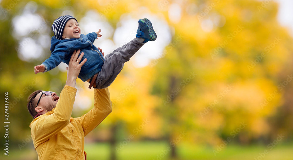 family, childhood and fatherhood concept - happy father and little son playing and having fun outdoors over autumn park background - obrazy, fototapety, plakaty 