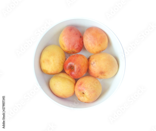 peaches in a bowl isolated on white