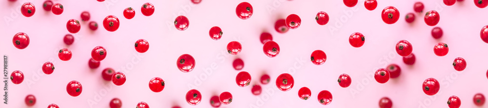 Red currant berries are falling on a pink background. Healthy eating concept. Red currant berries are falling on a pink background. Healthy eating concept.