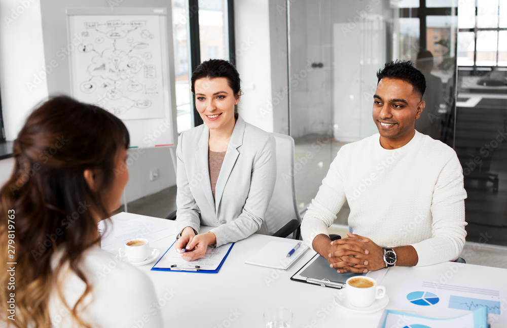 new job, hiring and employment concept - international team of recruiters having interview with female employee at office new job, hiring and employment concept - international team of recruiters having interview with female employee at office