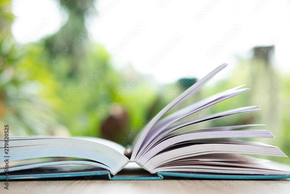 open book on wooden table in nature open book on wooden table in nature