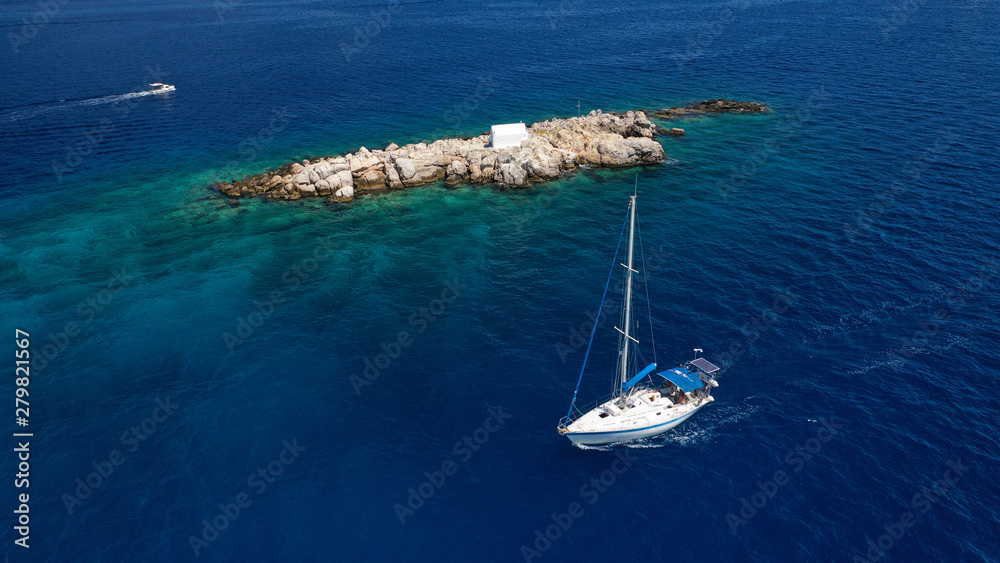 Obraz premium Aerial drone photo of small picturesque chapel of Agios Nikolaos built in small islet near picturesque main town of Hydra or Ydra island, Saronic gulf, Greece